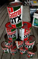 Pyramid stack of Castrol GTX motor oil tins showing quantity and label design