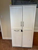 Front view of closed white cupboard