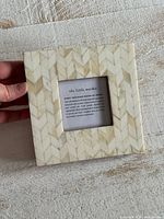 Front of square shell inlay photo frame showing chevron pattern and brand insert