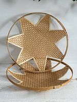 Two round wicker star baskets standing and lying flat