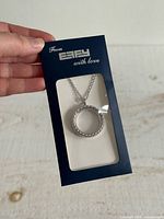 Pendant necklace in retail display sleeve