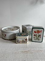 Group view of four floral tins