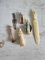 Group of six religious miniatures on white surface