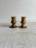 Two brass candlestick holders front view