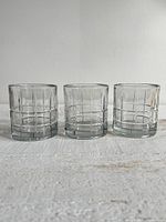 Three Anchor Hocking Manchester plaid clear lowball glasses side-by-side