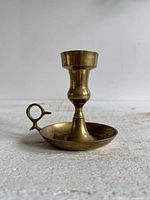 Full view of brass candlestick holder with finger loop