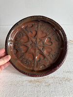 front view of glazed heart motif plate