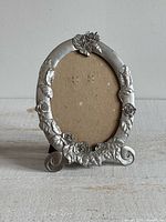 Front view of Seagull Pewter oval photo frame with rose embellishments