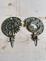 Front view of both sun and moon sconces