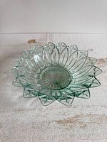 Oblique view of blue-tinted pressed glass flower bowl showing petal rim
