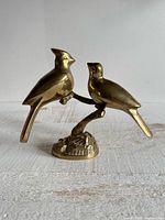 Front view of brass bird couple figurine on branch and round base