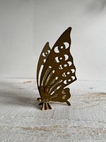 Front view showing brass butterfly silhouette and candle socket