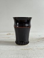 Front view showing glaze, band, and textured base