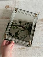 Top view of mirrored tray showing lucite rails and brass corners