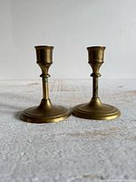 Front view of both brass candlestick holders