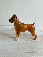 Full side view of plastic boxer dog figurine