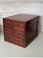 Front view showing six drawers with metal pulls and label holders