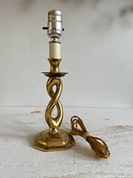 Full view of brass table lamp showing twisted post, socket, and cord