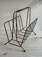 Oblique view of the wire magazine rack showing overall design and condition