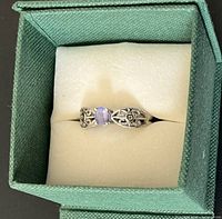 Ring in box, showing front filigree detail and tanzanite