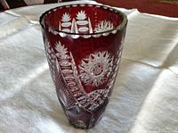 Front view of ruby red cut-to-clear crystal vase showing starburst and lattice cuts