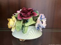 Front view showing multicolor porcelain flowers in bowl