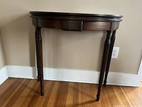 Front view of demilune console table closed