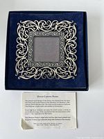 Frame seated in blue box with information card