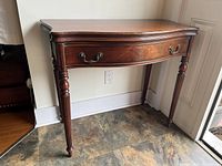 Closed demi-lune table showing front, legs, and finish