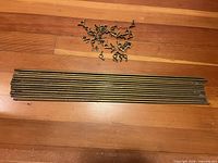 All 13 rods with pile of brackets and screws