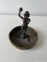 Top view showing ashtray interior and standing female figure