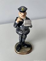 Front view of porcelain policeman figurine