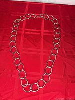 Full view of necklace laid flat showing overall design and clasp