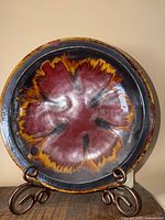 Front view of large glazed pottery bowl-plate showing full design and finish