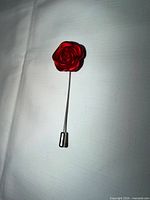 Front view of red rose stick pin showing rose head and full length