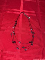 Necklace overall view on red background showing beads and strands