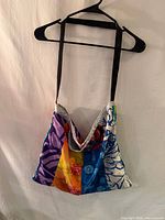 Full view of patchwork shoulder bag on hanger