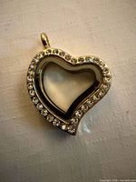 Front view showing heart shape, clear center, diamond accent rim