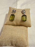 Full view of both earrings showing design and stones