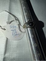 Ring front view on mandrel with size tag