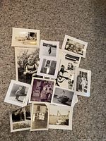 Group of vintage black & white photos spread on carpet