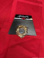 Front view of gold-tone scarf clip on Afterthoughts card