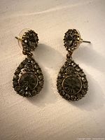 Front view of both earrings showing overall design, stones and metal tone