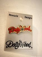 Front view of Dollywood enamel pin on Pinnacle Designs card