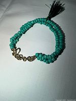 Full view of bracelet showing beads, Love link, tassel