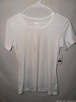 Front view of white T-shirt on hanger