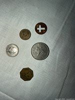 All five assorted coins laid out on fabric