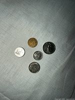 Five coins laid out showing obverse sides