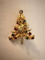 Front view showing gold-tone Christmas tree shape, elephant figure, GOP lettering, rhinestones