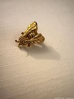 Front view of gold tone bumble bee brooch